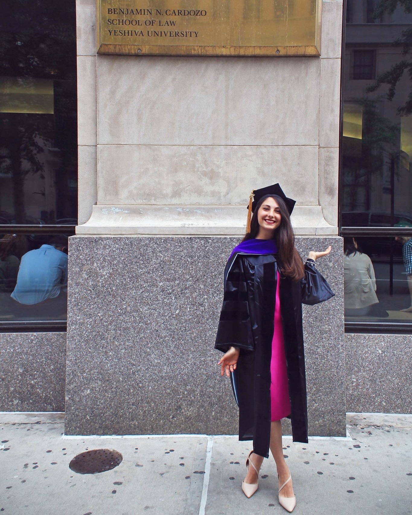 Radmila in a graduation gown outside Cardozo School of Law, Yeshiva University.