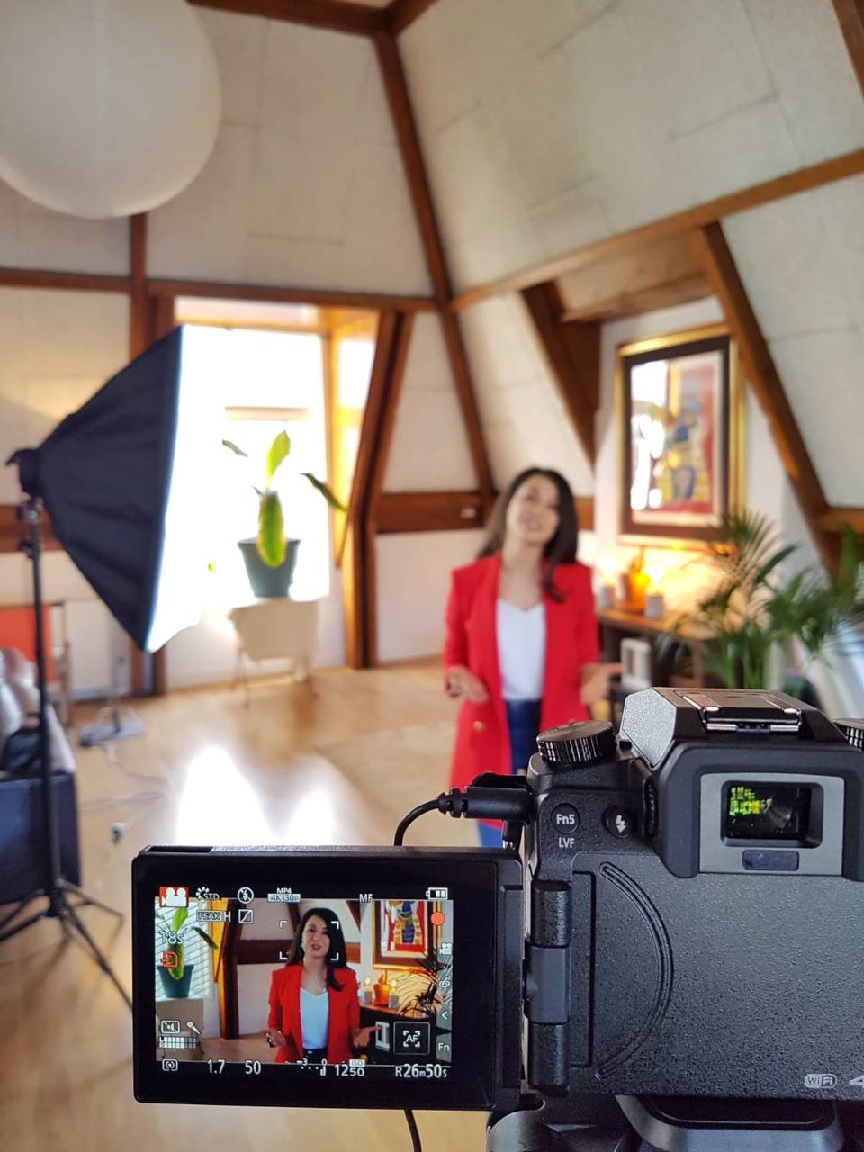 Radmila in a red blazer during a video shoot.